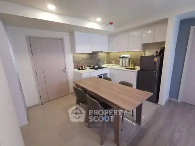 Modern kitchen with dining table and sleek appliances in a cozy apartment