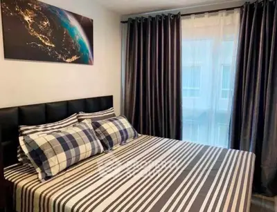 Cozy bedroom with stylish decor and natural light, perfect for relaxation.