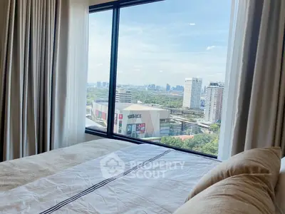 Luxurious bedroom with stunning city view through large window