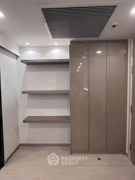 Modern interior with sleek storage and floating shelves in a minimalist design.