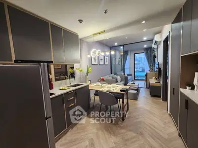 Modern open-layout kitchen and living room with stylish decor and city view.