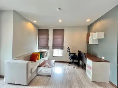 Modern living room with stylish furniture and natural light, perfect for relaxation and productivity.
