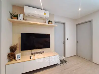 Modern living room with wall-mounted TV and air conditioning unit, featuring sleek wooden cabinetry and decor.