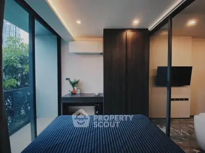 Modern bedroom with balcony access and sleek design in urban apartment