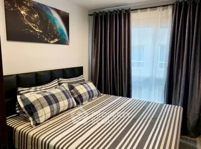 Cozy bedroom with stylish decor and large window for natural light