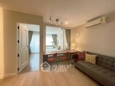 Modern living room with stylish decor and cozy ambiance, featuring a comfortable sofa and elegant lighting.