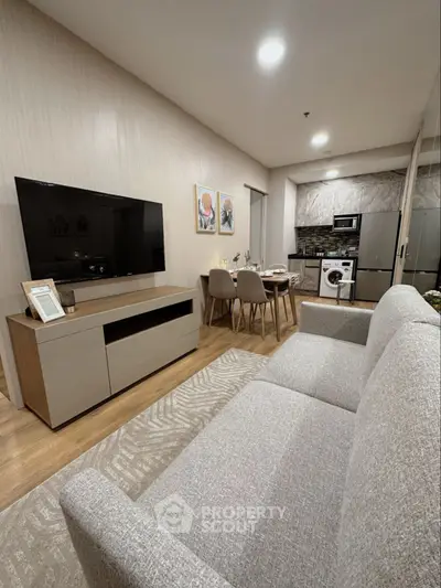 Modern living room with sleek furniture and open kitchen layout, perfect for urban living.