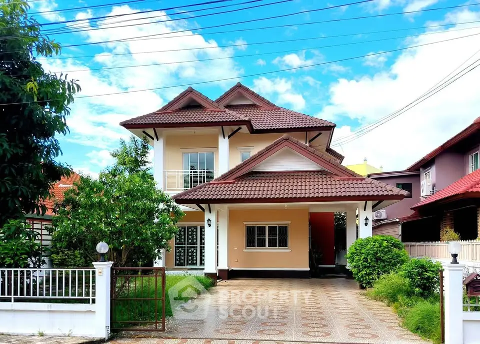 Charming two-story house with spacious driveway and lush greenery, perfect for family living.