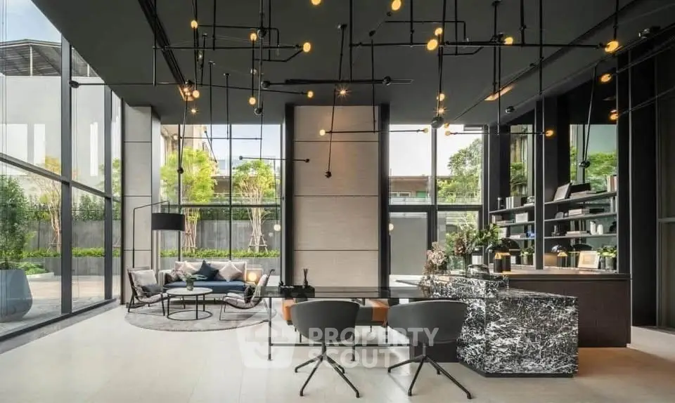 Luxurious modern living room with floor-to-ceiling windows and stylish lighting fixtures.
