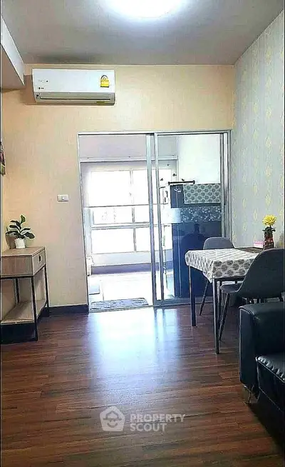 Charming apartment interior with modern dining area and sleek kitchen view.