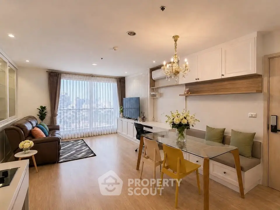 Spacious modern living room with city view, elegant decor, and natural light.
