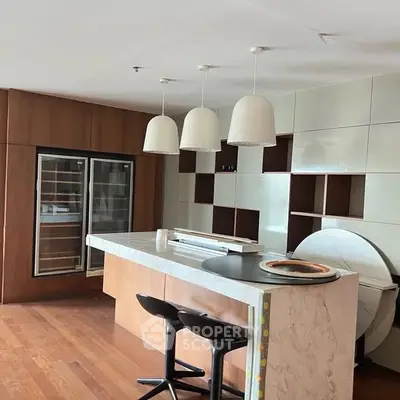 Modern kitchen with marble island and stylish pendant lights