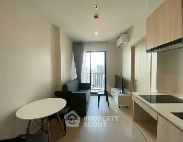 Modern living room with balcony and open kitchen in stylish apartment