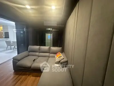 Modern living room with plush gray sofa and sleek wooden flooring