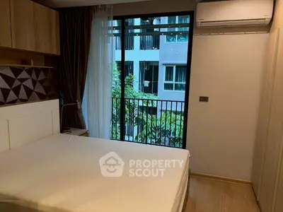 Modern bedroom with large window and air conditioning, offering a cozy and comfortable living space.