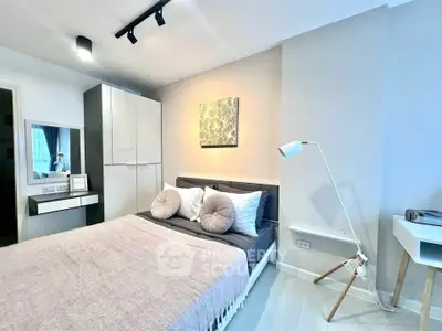 Modern bedroom with stylish decor and ample natural light
