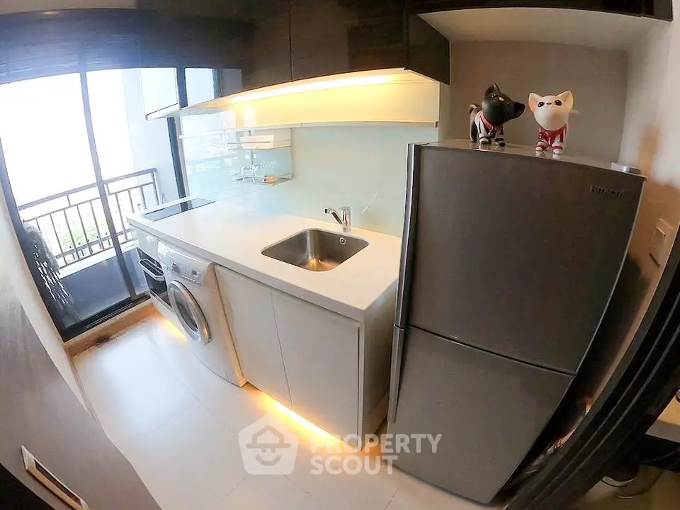 Modern kitchen with sleek appliances and balcony view