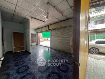 Spacious commercial space with tiled flooring and street view, ideal for business setup.