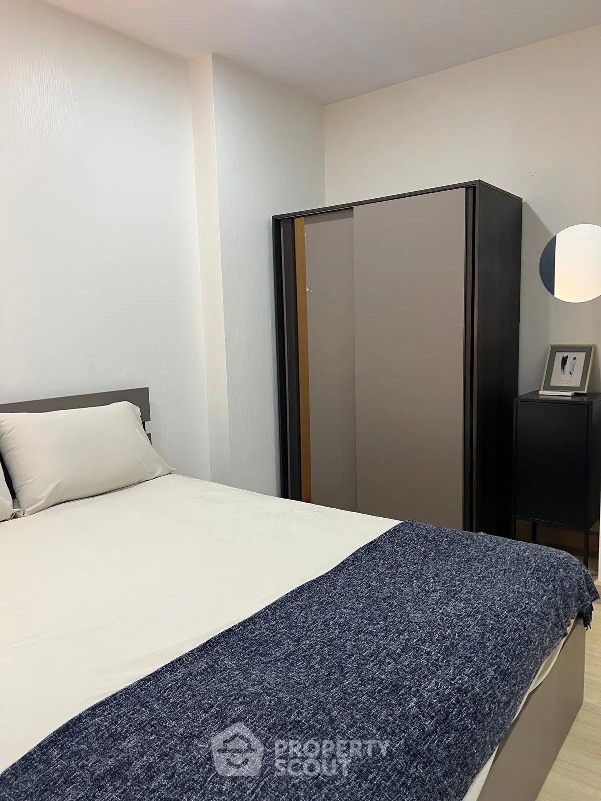 Cozy bedroom with modern wardrobe and stylish decor, perfect for restful nights.