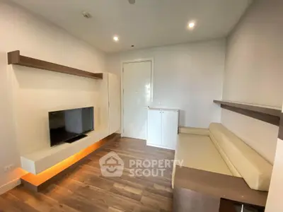 Modern minimalist studio apartment with sleek wooden flooring, built-in shelves, and ample natural light, perfect for urban living.