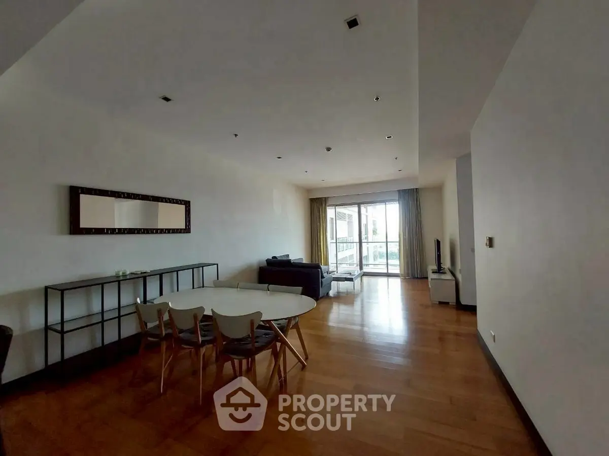 Spacious living room with modern furniture and large window view