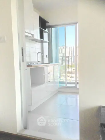 Modern kitchen with open layout and city view from balcony
