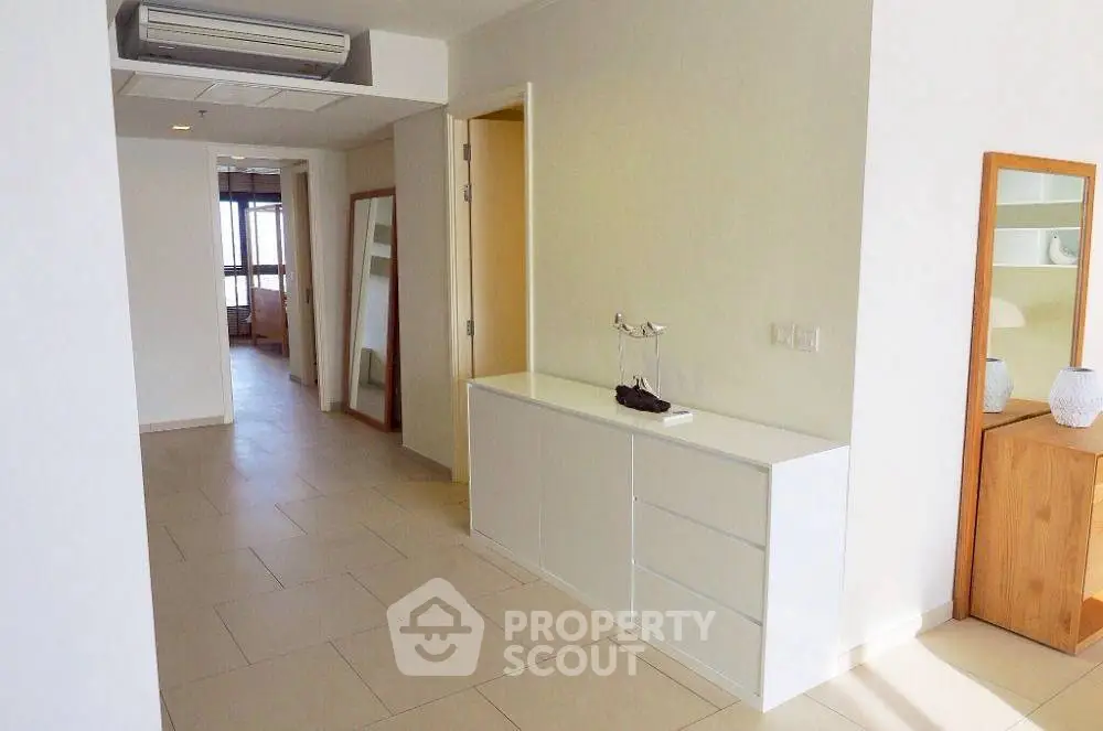Spacious hallway with modern decor and natural lighting in a stylish apartment.
