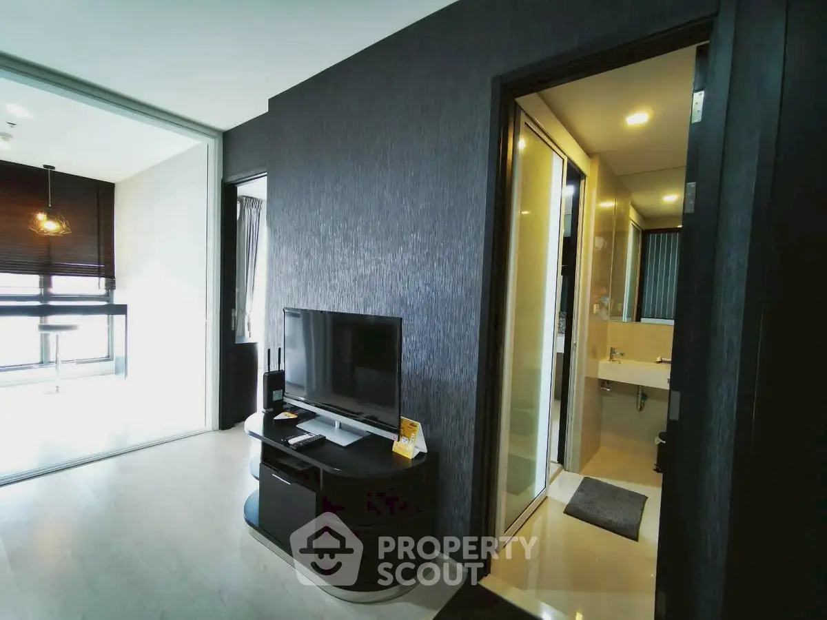 Modern apartment interior with sleek living room and bathroom, featuring contemporary design and ample natural light.