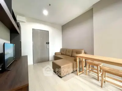 Modern living room with cozy sofa and wooden dining set in a stylish apartment.