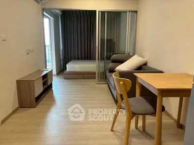 Modern studio apartment with open layout and balcony access