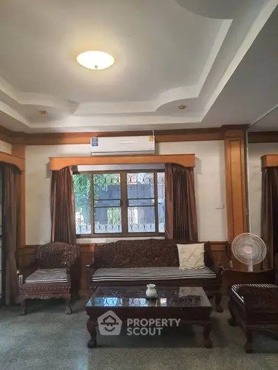 Elegant living room with classic wooden furniture and air conditioning