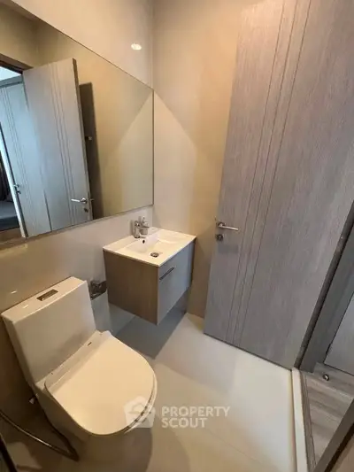 Modern bathroom with sleek fixtures and minimalist design in a contemporary apartment.