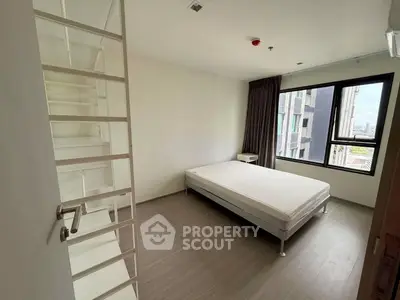 Modern minimalist bedroom with large window and sleek flooring
