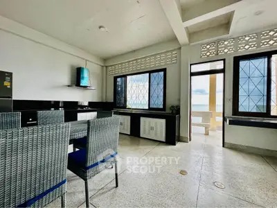 Spacious kitchen with ocean view and modern dining set