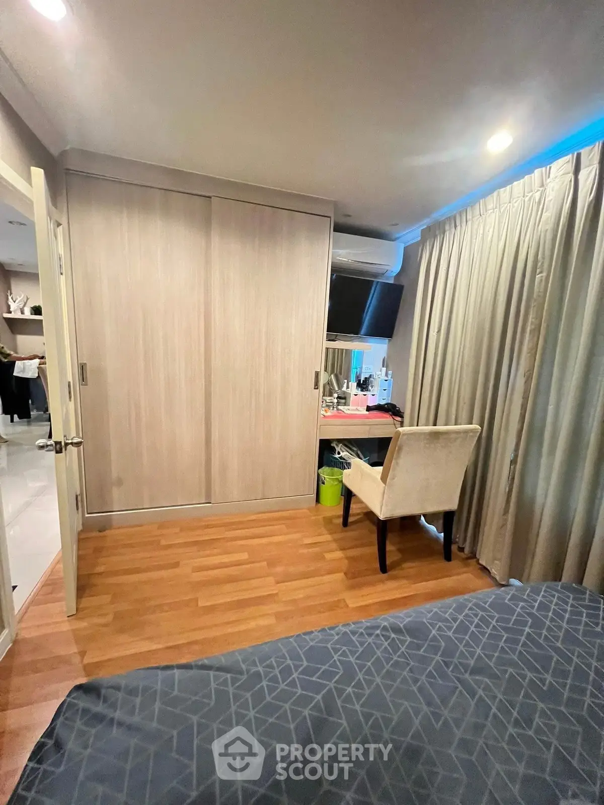 Cozy bedroom with wooden flooring and stylish furniture