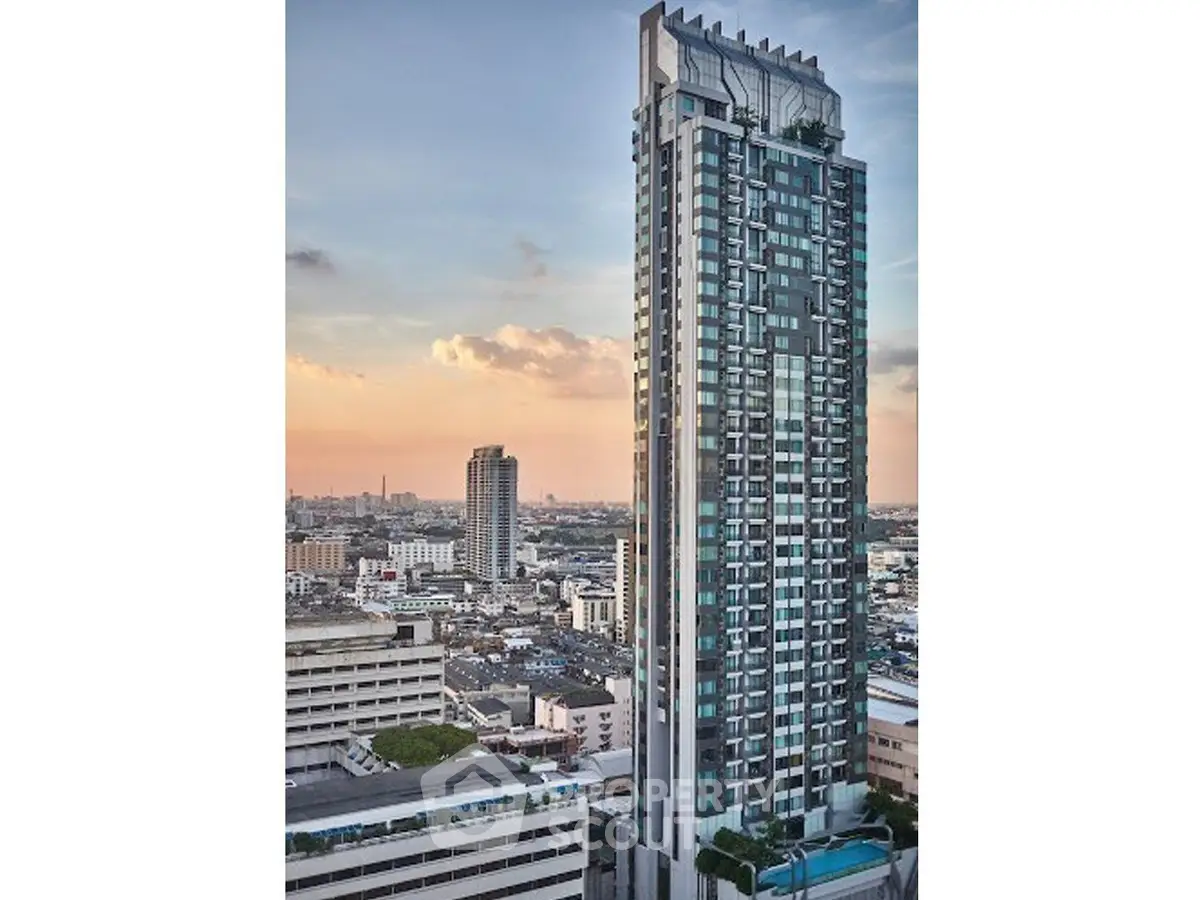 Stunning high-rise building with panoramic city views at sunset, perfect for urban living.