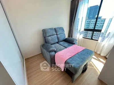 Cozy living room with plush recliner and city view, perfect for relaxation.