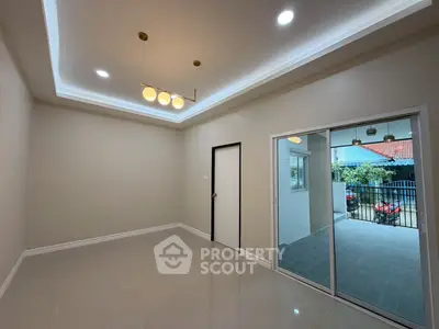 Spacious modern living room with elegant lighting and sliding glass doors to patio.