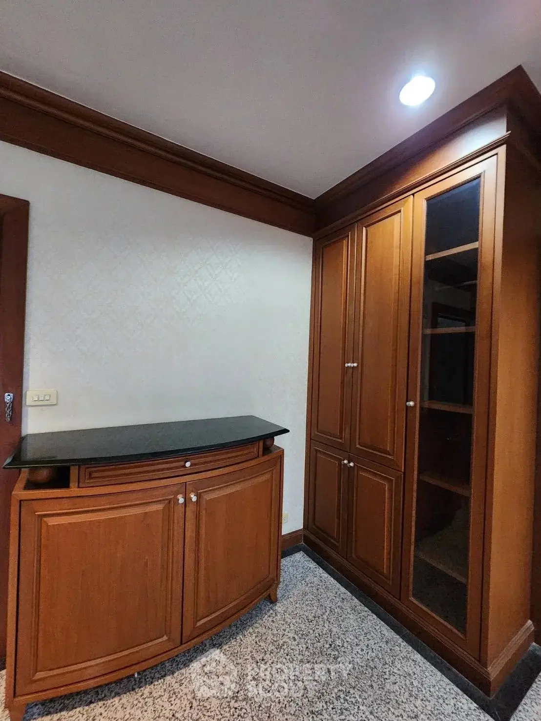 Elegant wooden storage cabinets in a modern interior space with ambient lighting.