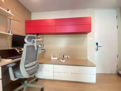 Modern study room with ergonomic chair and built-in desk in stylish apartment.