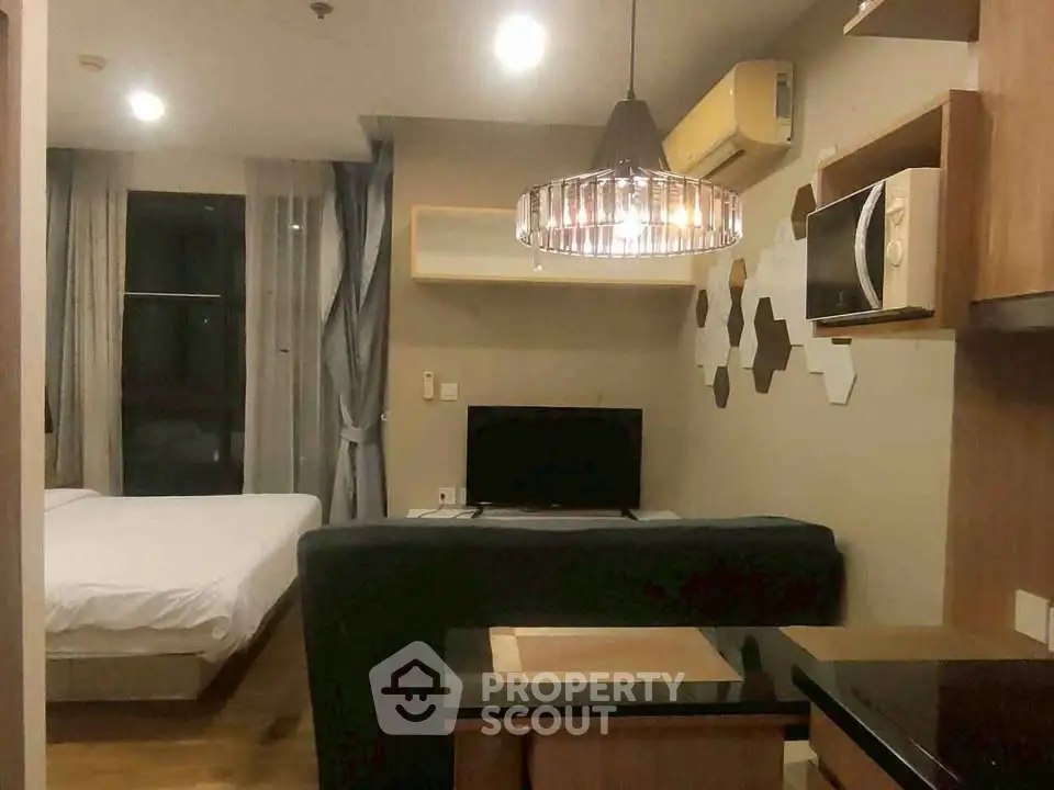 Modern studio apartment with cozy living area and stylish kitchen