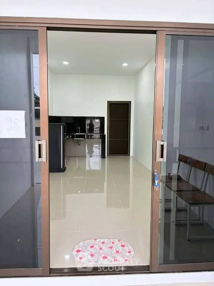 Modern interior with sliding glass doors, sleek flooring, and minimalistic design, perfect for contemporary living.