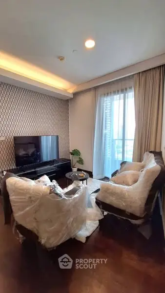 Luxurious living room with modern decor and large window for natural light.