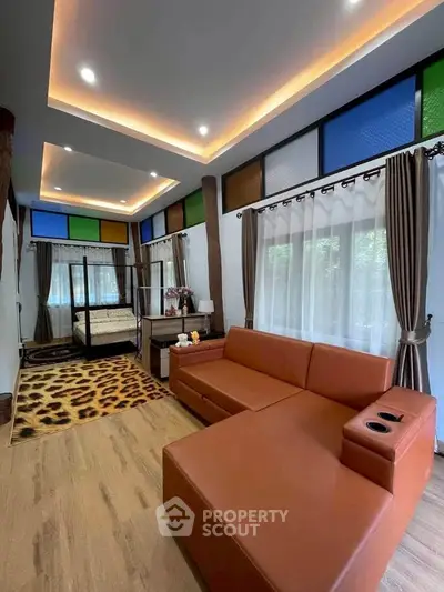 Stylish living room with modern furniture and vibrant ceiling lights