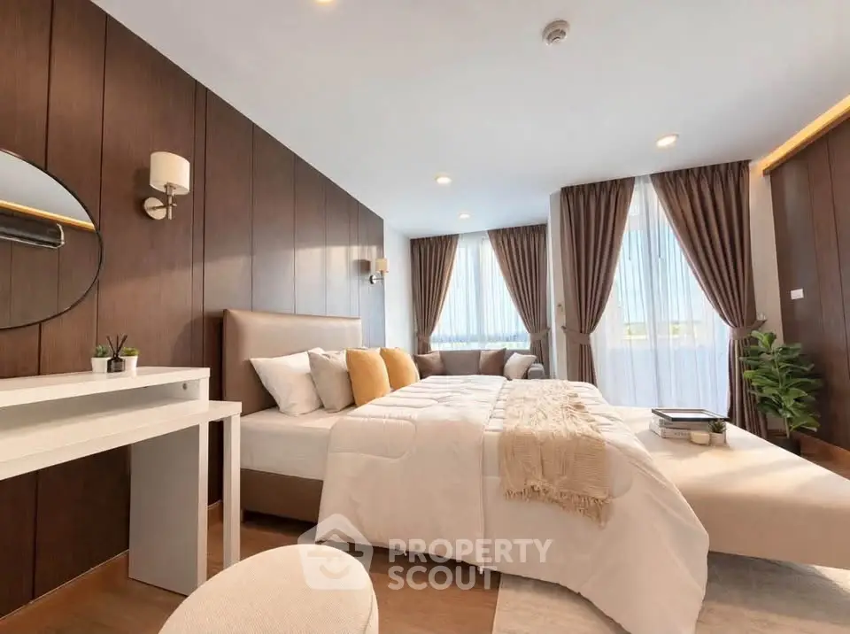 Luxurious bedroom with elegant decor, featuring a cozy bed, stylish lighting, and large windows with curtains.