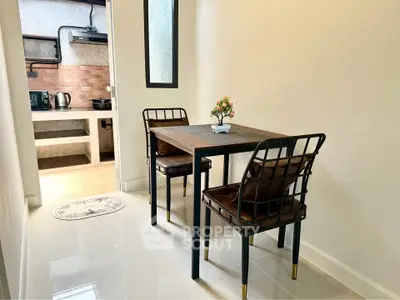 Cozy dining area with modern kitchen in stylish apartment