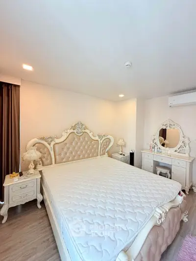 Luxurious bedroom with elegant furniture and plush mattress in a bright, airy space.