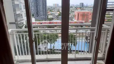 Stunning balcony view overlooking cityscape and pool, perfect for urban living.