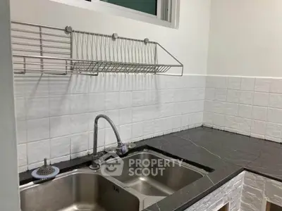 Modern kitchen with double sink and sleek countertop design