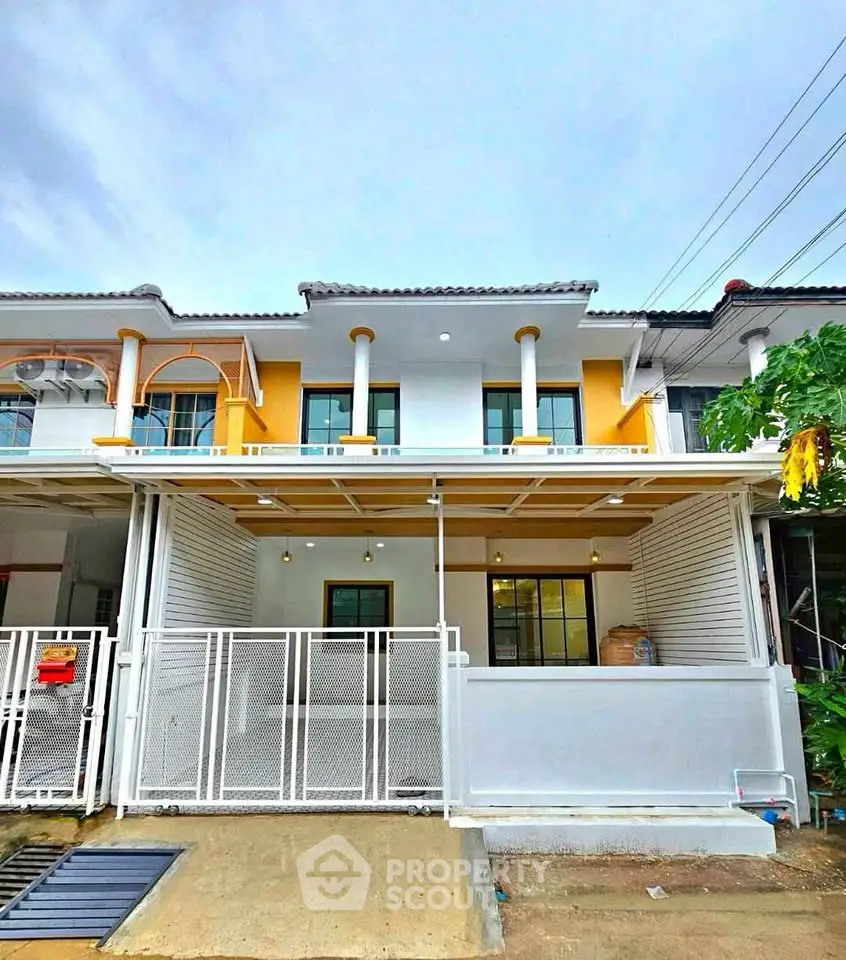 Charming townhouse exterior with modern design and gated entrance, perfect for urban living.